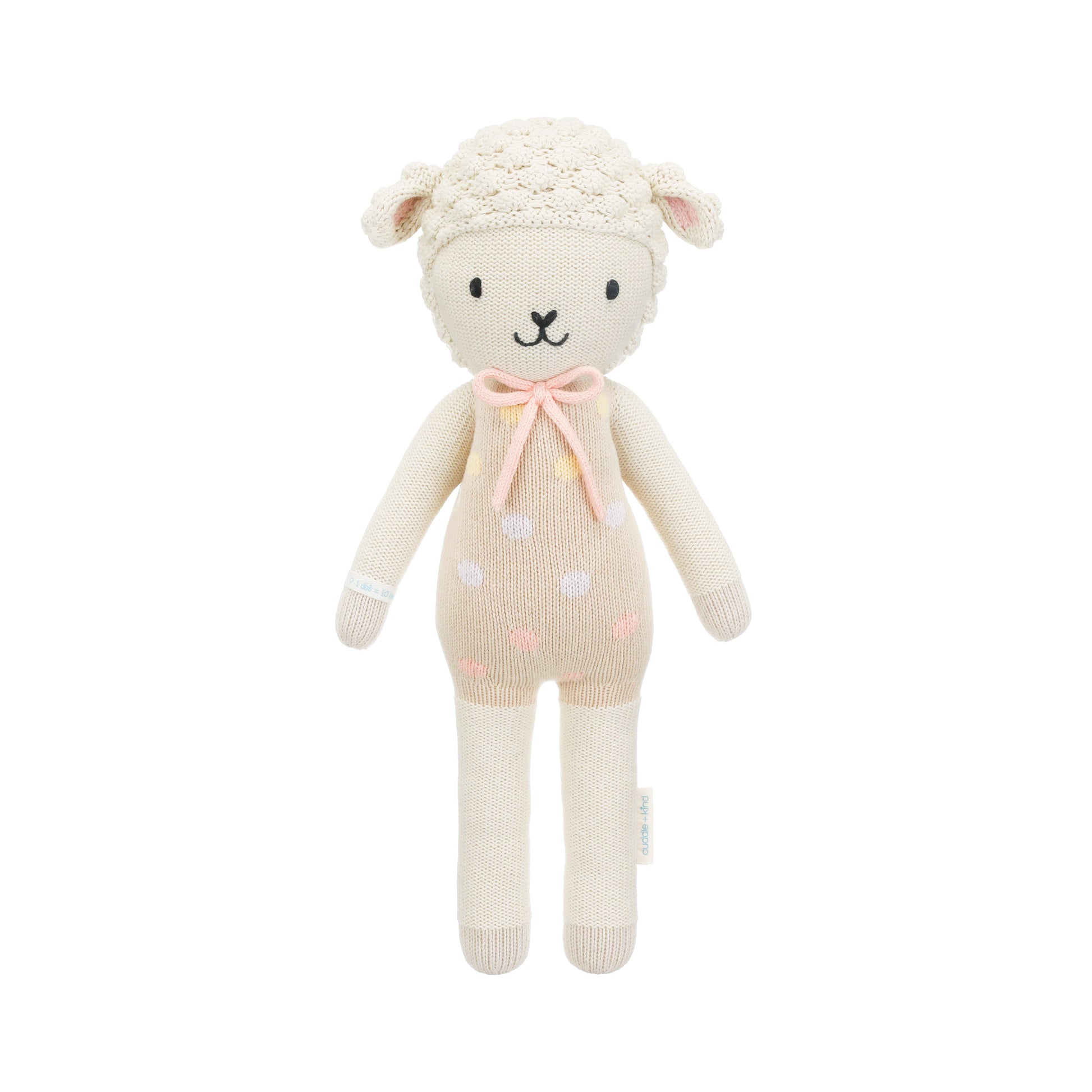 Lucy the lamb shown from 360°. Lucy has a pastel pink outfit with polka dots and a pastel pink yarn bow.