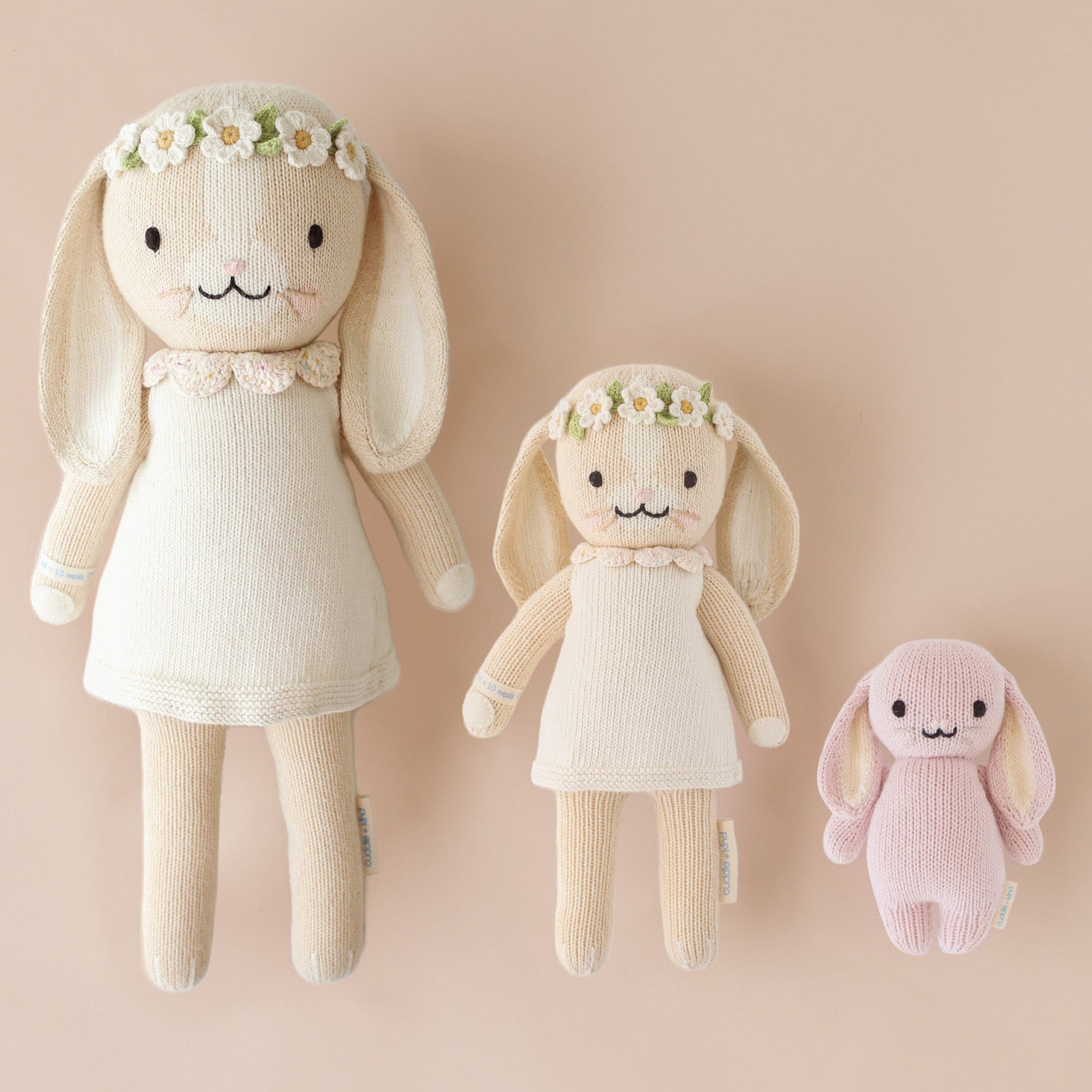 Three hand-knit dolls from cuddle and kind: Hannah the bunny in the regular and little sizes, and baby bunny in lilac.